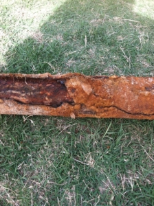 Cracked and split cast iron sewer pipe